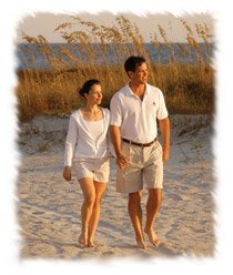 David Love and Kathy Love waling on the beach in Sea Pines